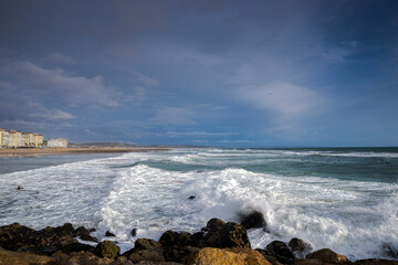 Surfing in the Costa da Caparica Beach, a famous place for water sports in Portugal.