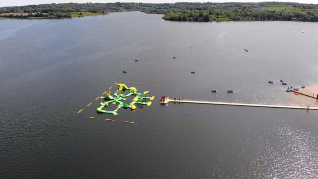 inflatable water park on Bewl Water reservoir lake sunny day aerial