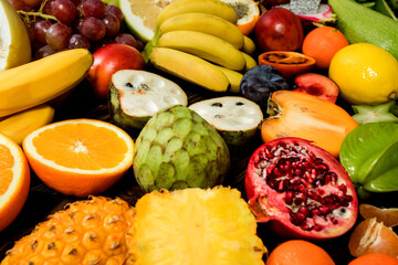Table with fruit, tropical variety of mixed fruits on wooden background