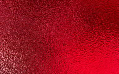 Red shiny foil metallic paper texture background. Use for christmas and valentine day concept.