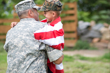 Happy reunion of soldier with family outdoors

