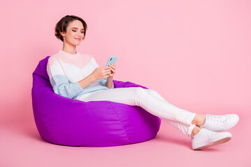 Full size profile photo of adorable person sitting write blog post have good mood isolated on pink...