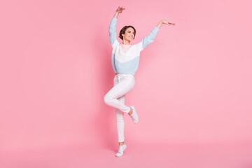 Photo portrait full body view of dancing woman isolated on pastel pink colored background