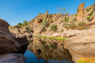 Lake Bear Gulch and rock formations in Pinnacles National Park in California, the ruined remains of...