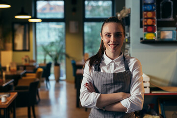 waitress standing crossed arms in cafe