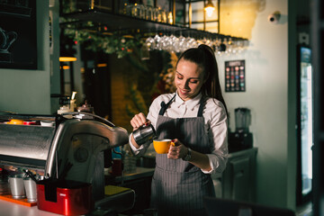 waitress preparing espresso coffee in cafeteria or coffee shop