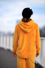 Young woman dressed in fashion hoodie posing outdoor