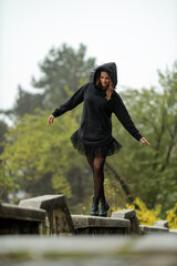 Young woman dressed in fashion hoodie posing outdoor