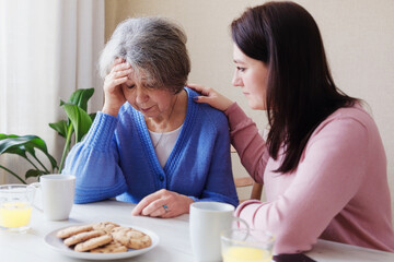 Daughter consoles an elderly mother in illness - A pensioner woman has a bad diagnosis and is...