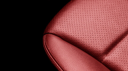 Modern luxury car red leather interior. Part of red leather car seat details with stitching. Interior of prestige car. Comfortable perforated leather seats. Perforated leather.