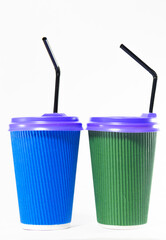 Two paper cups with a lid for coffee, latte on a white background. Green and blue paper cups. Fast food concept.