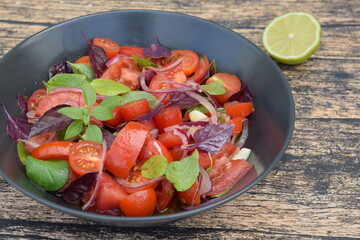 Tomato basil salad with purple basil, lime juice and red onion