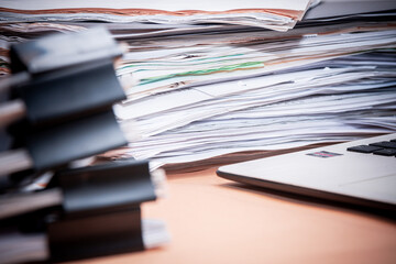 A bunch of financial statements. Some documents are on a paper clip. Selective focus.