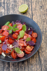Tomato basil salad with purple basil, lime juice and red onion