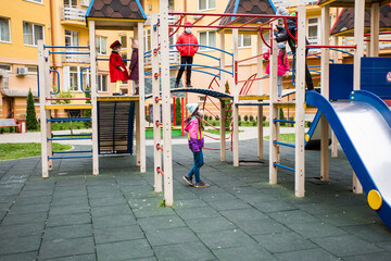 Fototapeta na wymiar The friends meet on the playground during a pandemic