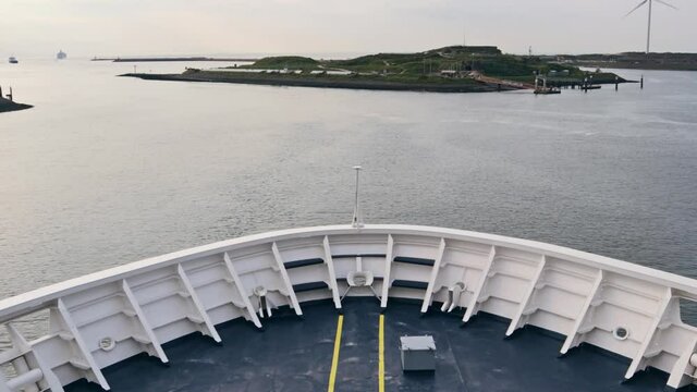 Bow of large ship ferry leaving a river port and heading out to sea - Timelapse
