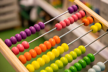 Bright colored hand abacus. Children's wooden toy for the study of arithmetic.