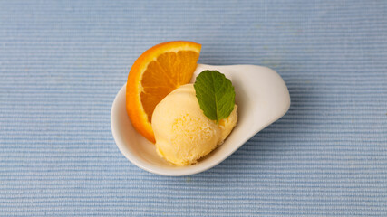 Fresh scoop of orange sorbet as fruit ice cream with orange