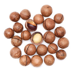 Shelled and unshelled macadamia nuts on white background