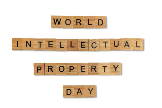 Top view of the word world intellectual property day laid out from square wooden tiles isolated on white background. World and international day.