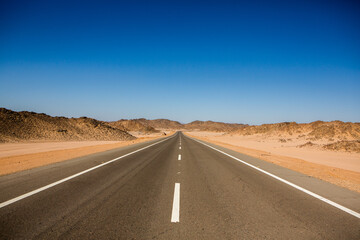 Road in the sahara desert of Egypt. Conceptual for freedom, enjoying the journey. Empty road. Freeway, Highway through the desert