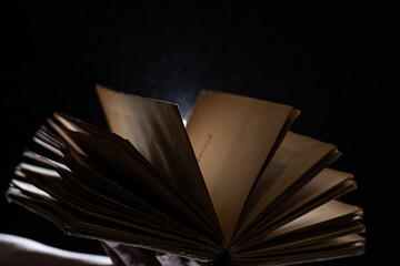 Vintage open Book Glows In The Darkness. Concept of wisdom and knowledge