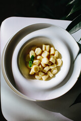 Italian gnocchi in a deep tarrel with white sauce
