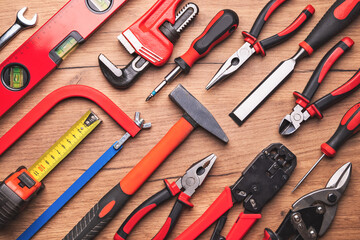 Assorted work tools on wooden background