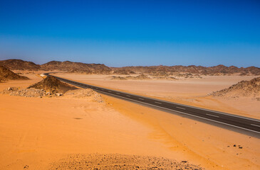 Road in the sahara desert of Egypt. Conceptual for freedom, enjoying the journey. Empty road. Freeway, Highway through the desert