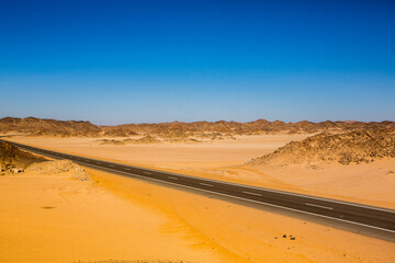 Road in the sahara desert of Egypt. Conceptual for freedom, enjoying the journey. Empty road. Freeway, Highway through the desert