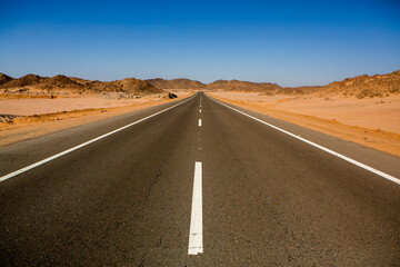 Road in the sahara desert of Egypt. Conceptual for freedom, enjoying the journey. Empty road. Freeway, Highway through the desert