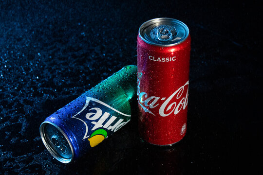 Coca cola and sprite soda cans with water drops on black background editorial stock photo. Pepsico brand company. Carbonated sweet soft drink. Pepsi logo. Illustrative material