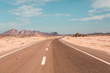 Road in the sahara desert of Egypt. Conceptual for freedom, enjoying the journey. Empty road. Freeway, Highway through the desert