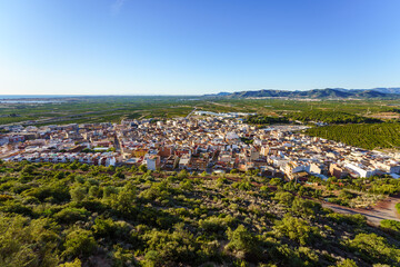 Almenara, Spain. December 9, 2020. High angle view on a sunny day of a city surrounded by orange-tree fields.