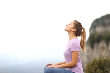 Woman sitting breathing fresh air in the mountain