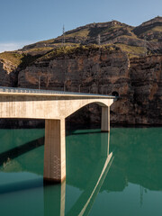 Modern concrete bridge over a reservoir filled with water. Comunidad Valenciana, Spain