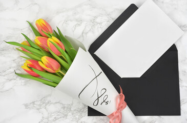 bouquet of tulips and a card, empty space for text entry, wishes, anniversary, birthday