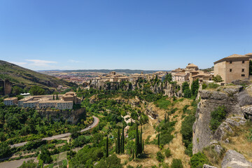 Fototapeta na wymiar River Huecar, Cuenca, Castilla-La Mancha from the top of this UNESCO World Heritage Spanish city in a sunny day. On the left side they are visible the Parador Nacional and the San Pablo bridge.