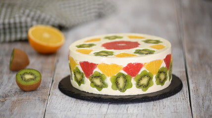 Delicious fruit mousse cake. Cake decorated with fresh fruits in jelly.