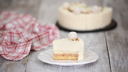 Piece of delicious coconut mousse cake with almonds.