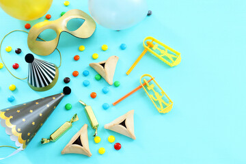 Purim celebration concept (jewish carnival holiday) over wooden table. Top view