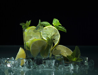 Fototapeta na wymiar Cocktail with lime, ice and mint.