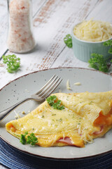 Omelette with ham and cheese on the plate