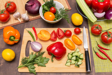 Different vegetables for cooking healthy vegetarian vegan diet food. Cutting vegetable on wooden board on kitchen