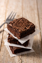 Homemade pieces of brownies on wooden table	