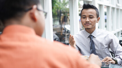 young Asian businessmen discussing outdoors