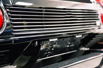 Fototapeta na wymiar metal dark grille in the bumper of a modern car