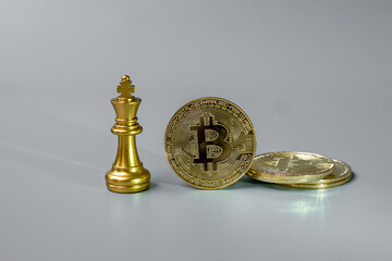 Fototapeta na wymiar golden Bitcoin cryptocurrency coin stack and Chess King piece, Crypto is Digital Money within the blockchain network, is exchanged using technology and online internet exchange. Financial concept