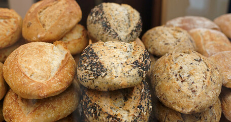 Buying bread at the store. A customer takes fresh bread with tongs at the bakery.
