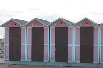 A set of pink beach huts with a wooden door in a bathhouse (Pesaro, Italy, Europe)